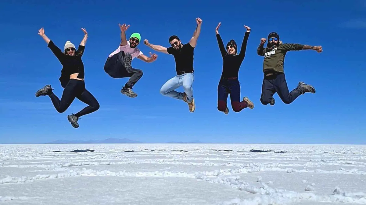 Flamingos wading in a high-altitude lagoon on a 4-day Uyuni salt flats tour from San Pedro de Atacama